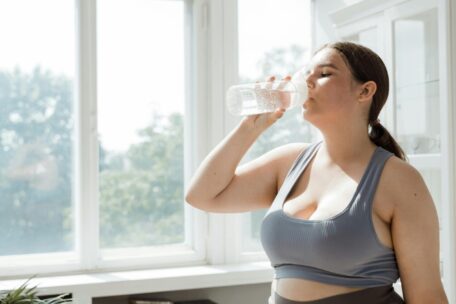 Woman drinking water to stay hydrated. Healthy lifestyle and hydration tips for well-being.