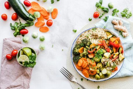 Healthy food bowl for Applied Nutrition Course. Fresh vegetables, quinoa, zucchini, carrots, tomatoes, and ginger. A nutritious meal.