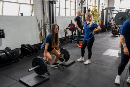 Personal Trainer coaching a client during a gym session
